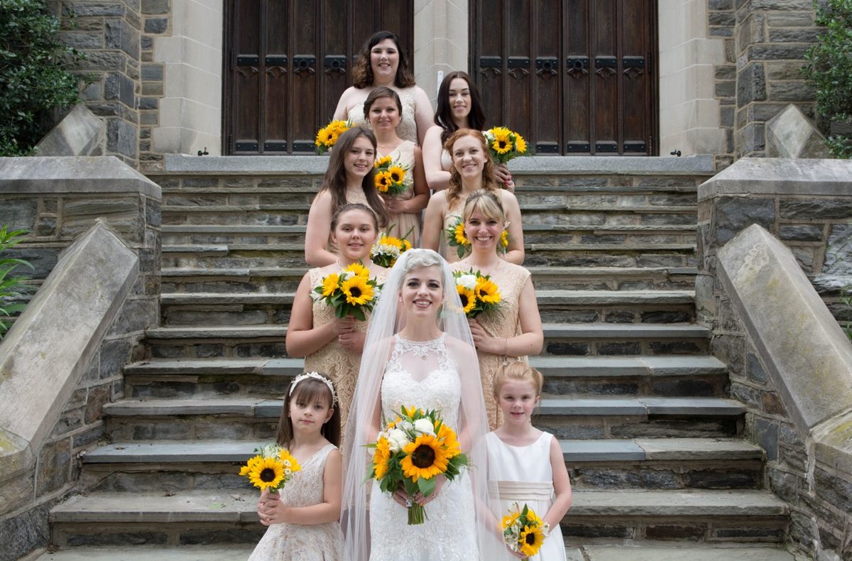 Wedding couple with sunflower bouquet from a Grand Detail event